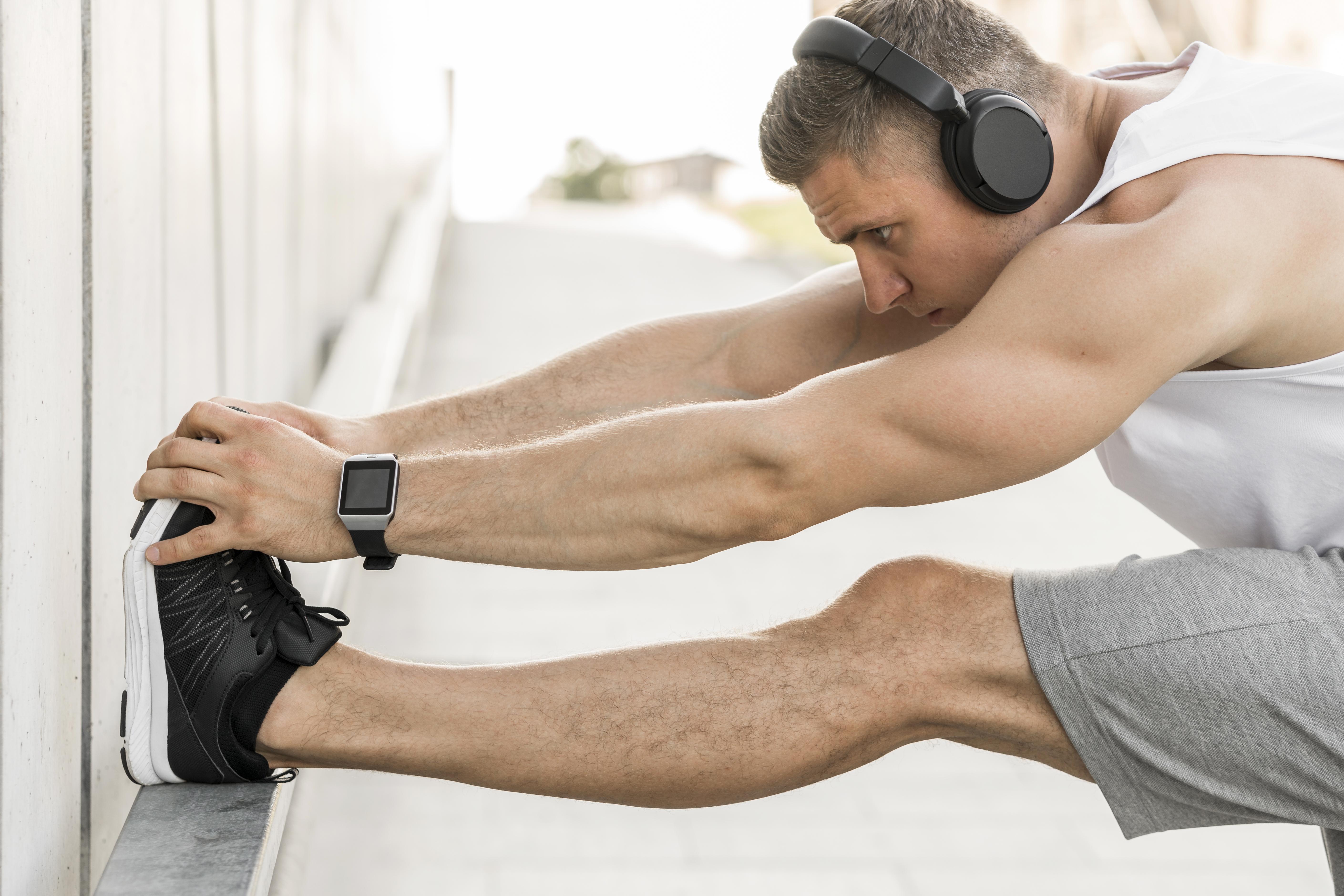 man-with-headphones-stretching-outside